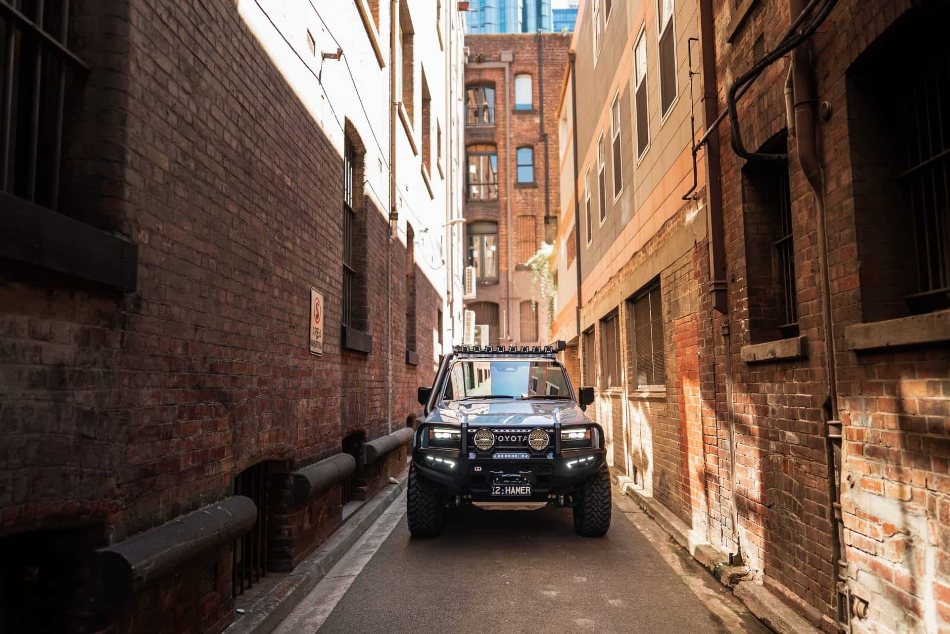 Toyota Landcruiser Prado 250 Series with West Coast Off Road bull bar in an alleyway.