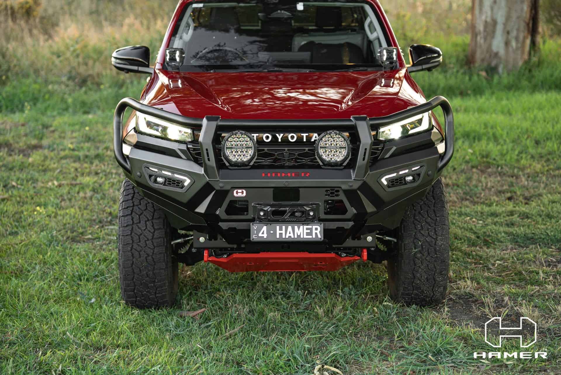 Toyota Hilux with West Coast Off Road Atlas Series Plus bull bar in red.