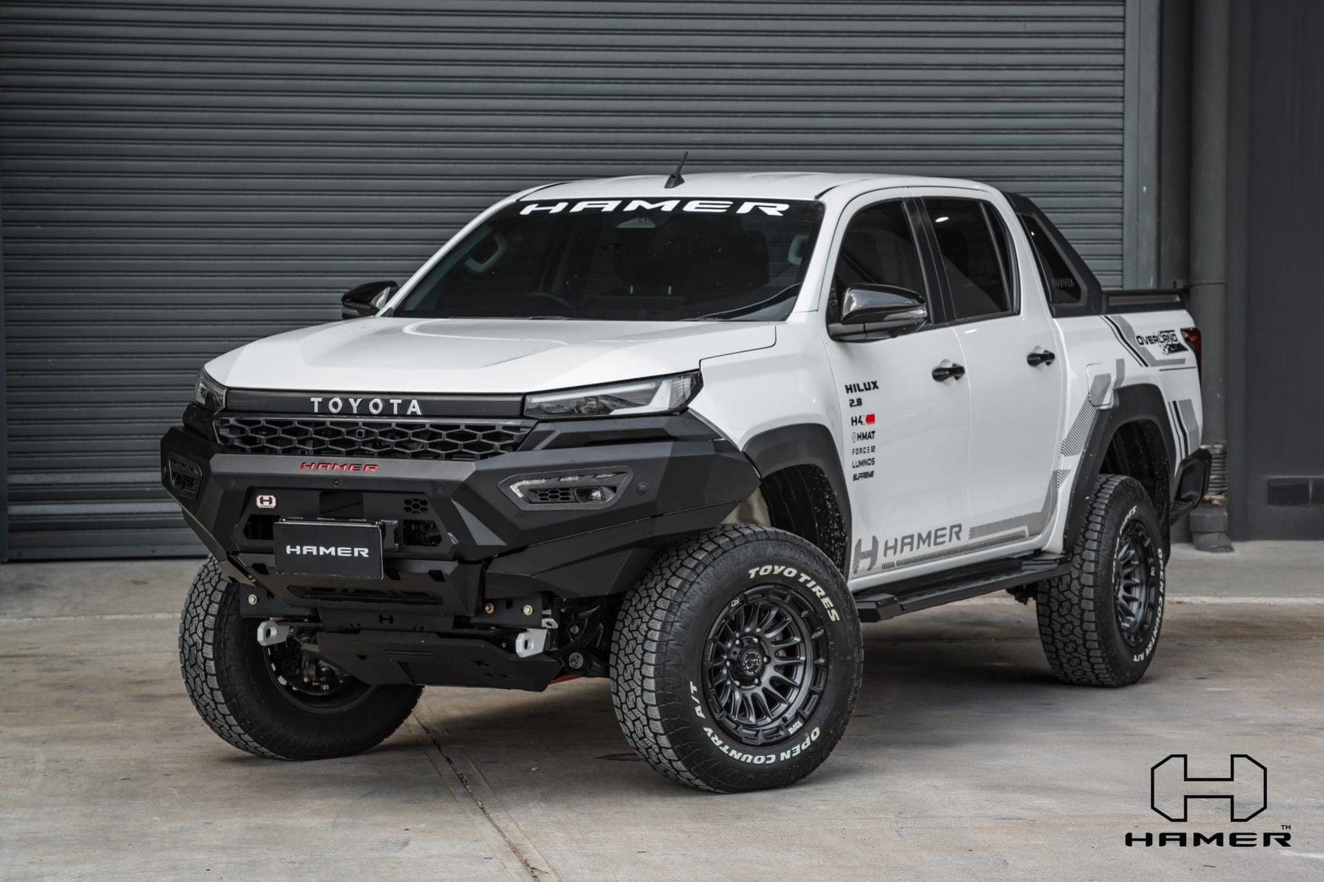 Toyota Hilux with West Coast Off Road Atlas bull bar and off-road tyres.