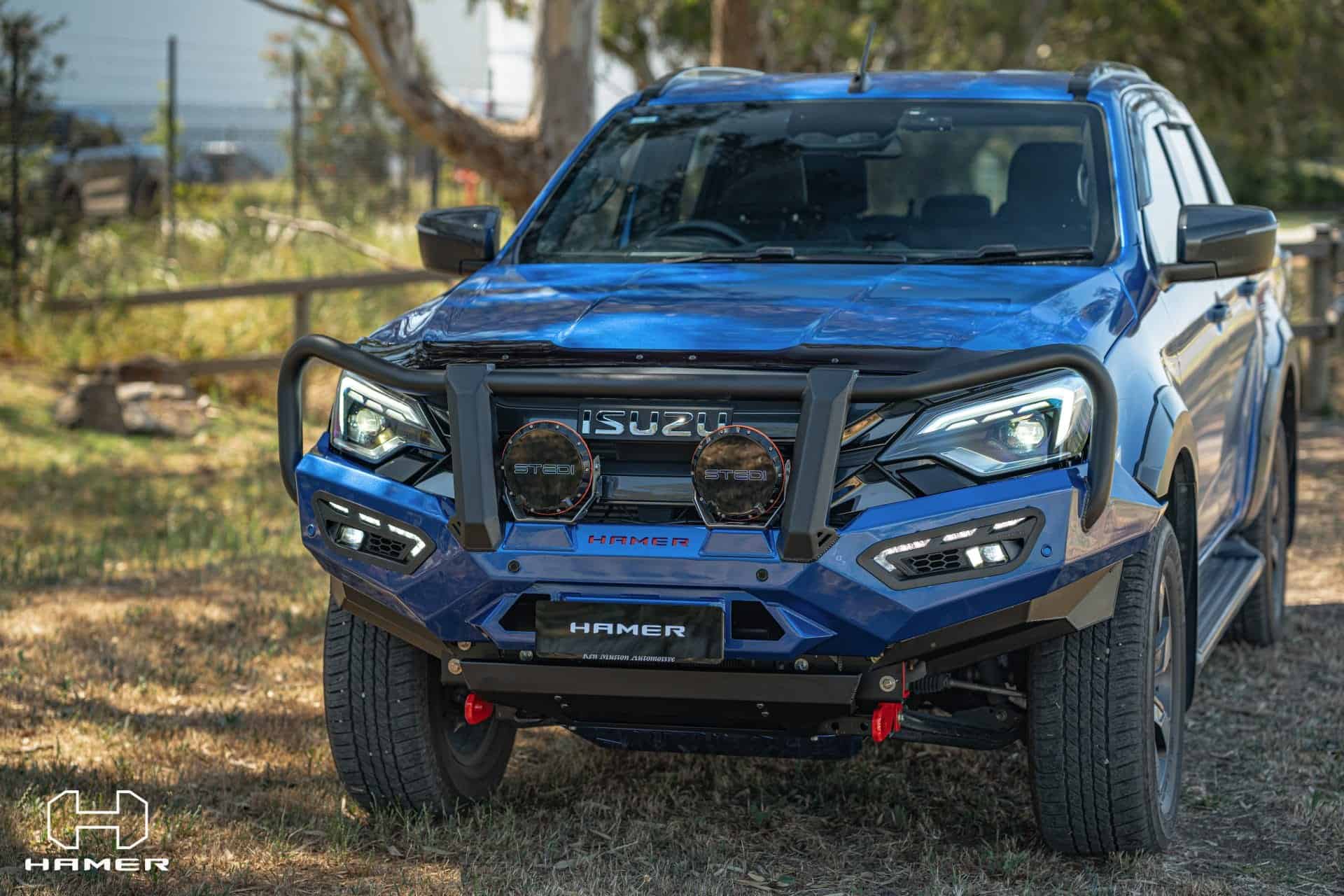 Blue Isuzu D-Max with West Coast Off Road bull bar and off-road lights.