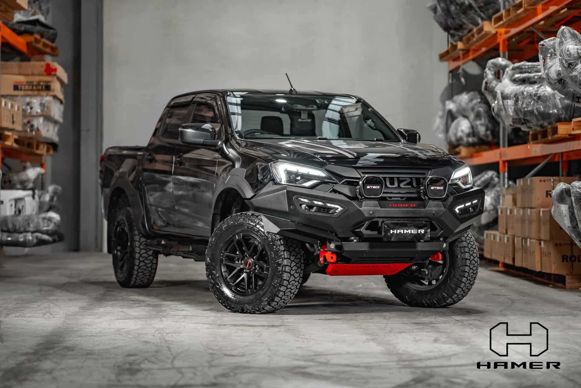 Black Isuzu D-Max with West Coast Off Road bull bar in warehouse.