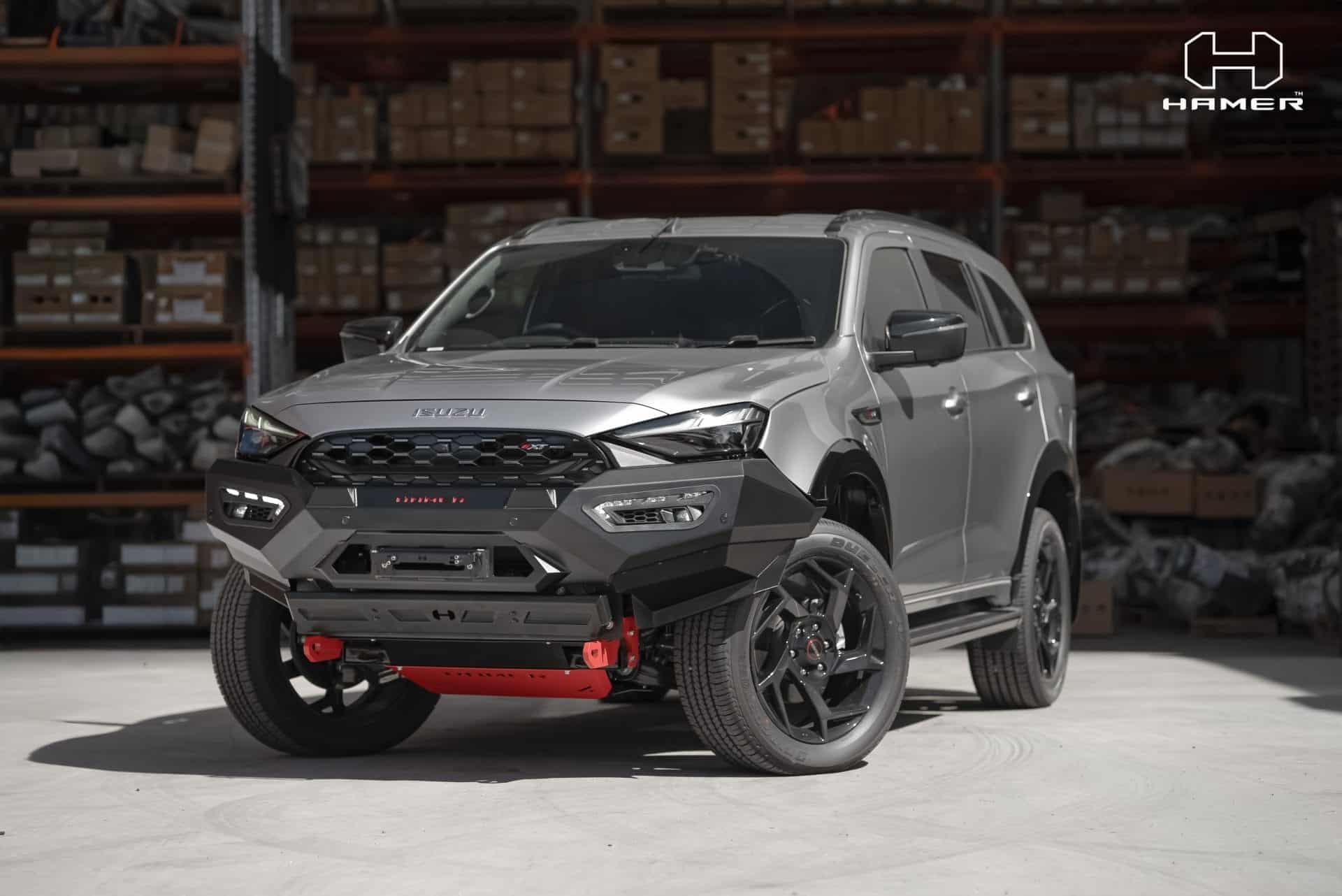Isuzu MU-X with West Coast Off Road Atlas bull bar in a warehouse.